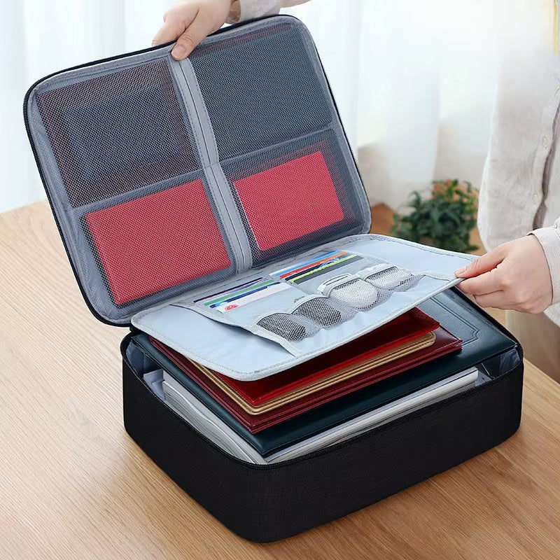 A black water-proof document storage bag with multiple compartments, some containing documents and personal items, displayed on a table.